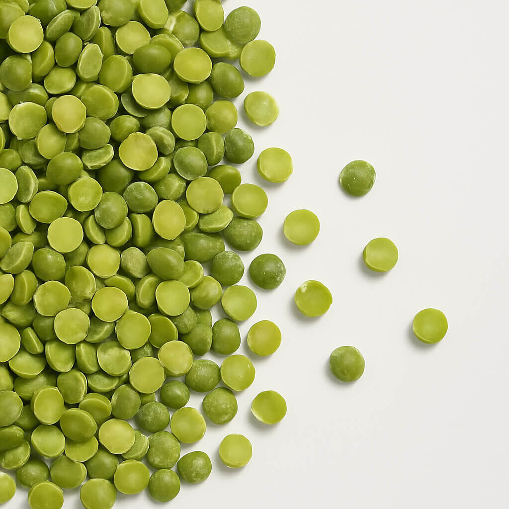 Close-up of green split peas on white background