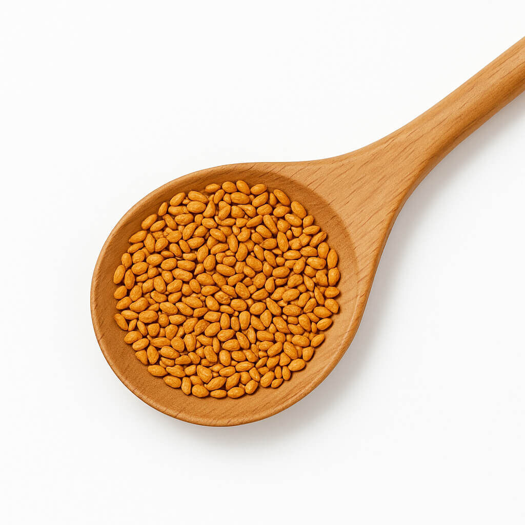 Wooden spoon filled with golden seeds on white background