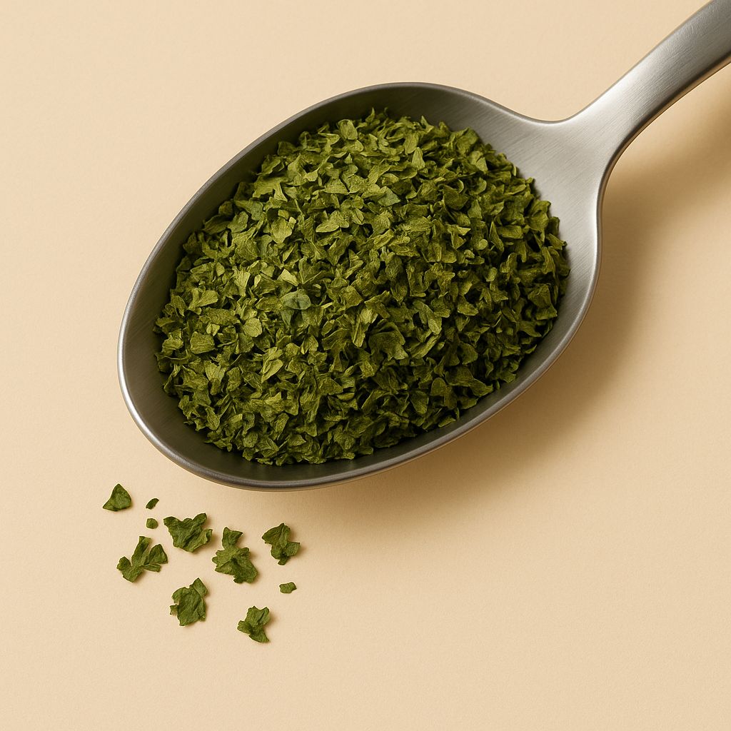 Spoonful of dried parsley leaves on a beige background