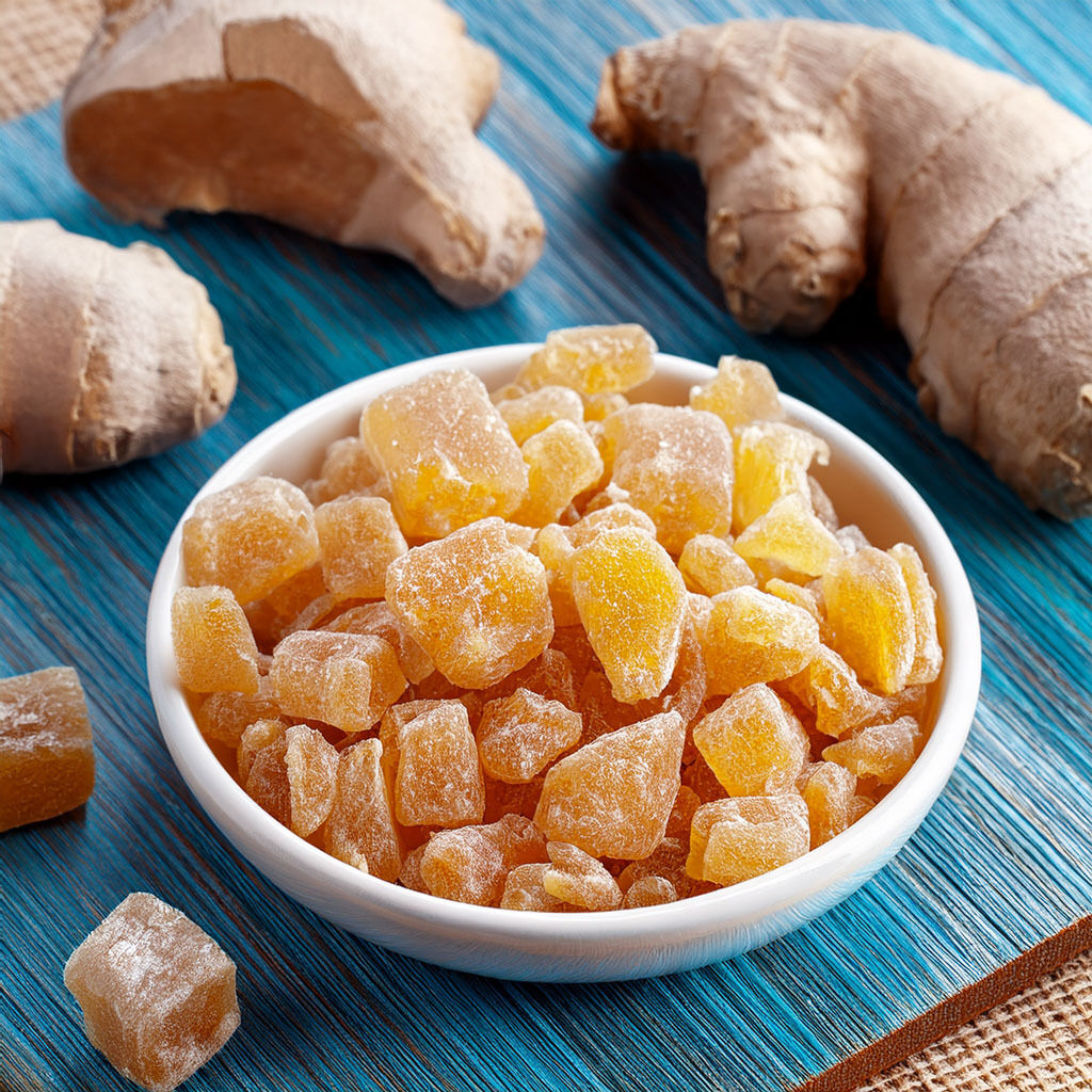 Bowl of crystallised ginger with fresh root