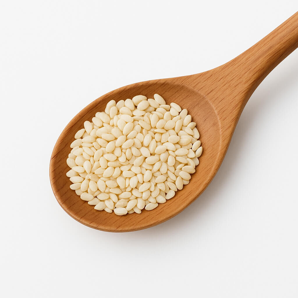 Close-up of white sesame seeds in wooden spoon