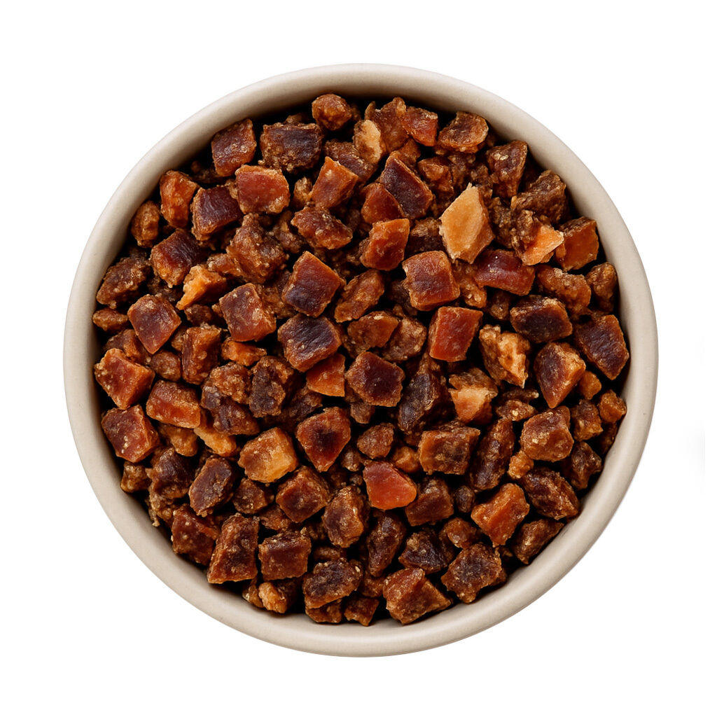 Top view of diced dried apricots in ceramic bowl