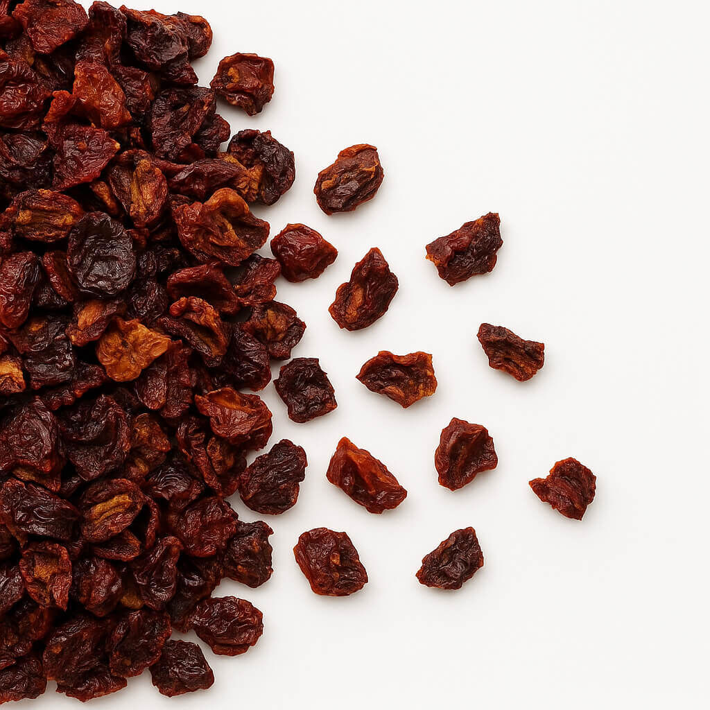 Dried cherries scattered on white background