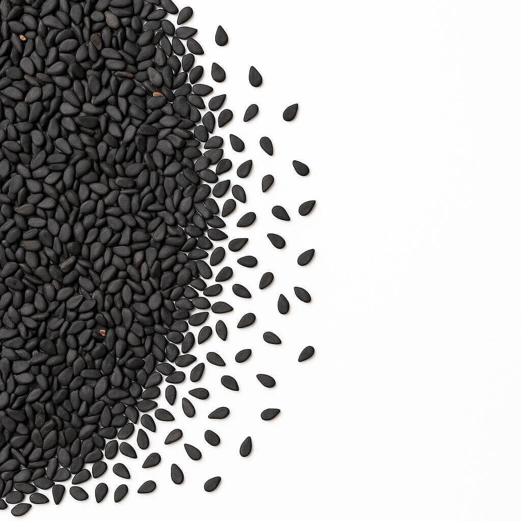 Black sesame seeds scattered on white background