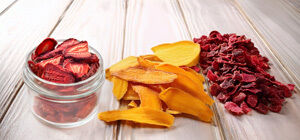 Dried strawberry, mango, and beetroot slices on white wooden