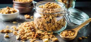 Close-up of granola in jar and wooden spoon