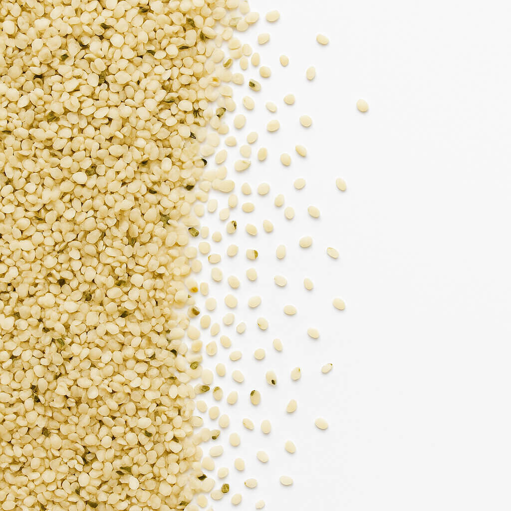 Close-up of hulled hemp seeds scattered