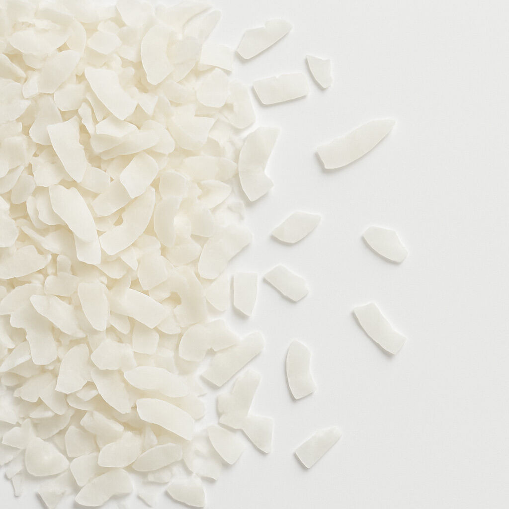 Dried coconut flakes scattered on white background