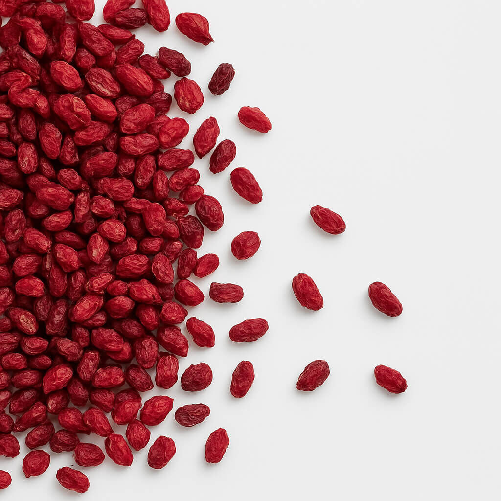 Dried goji berries scattered on white background