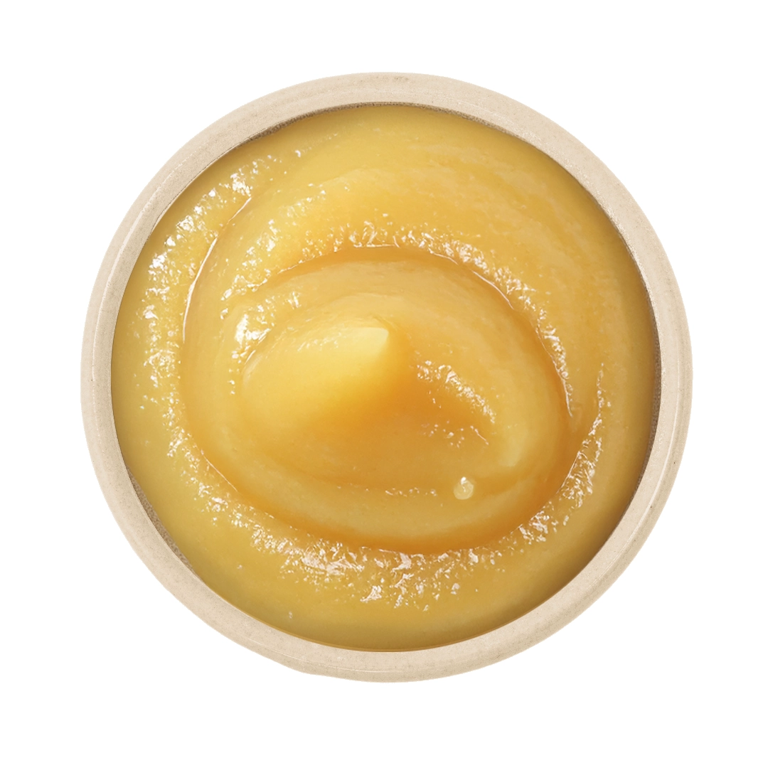 Topbillede af rund krukke med glat, cremet citroncurd i gylden gul farve