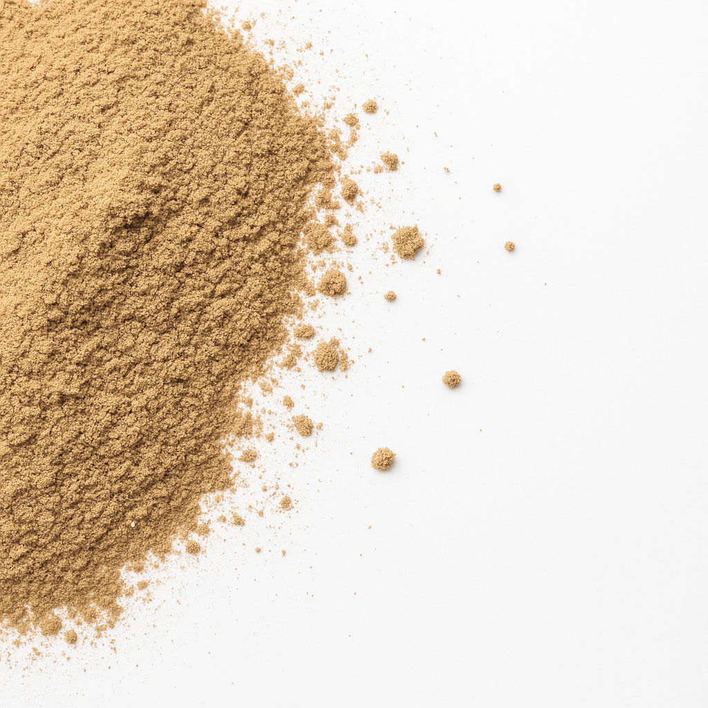 A pile of fine brown powder spread on a white background, highlighting texture and color.