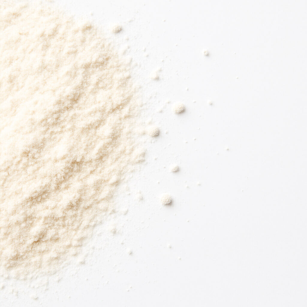 Fine beige powder pile on white surface