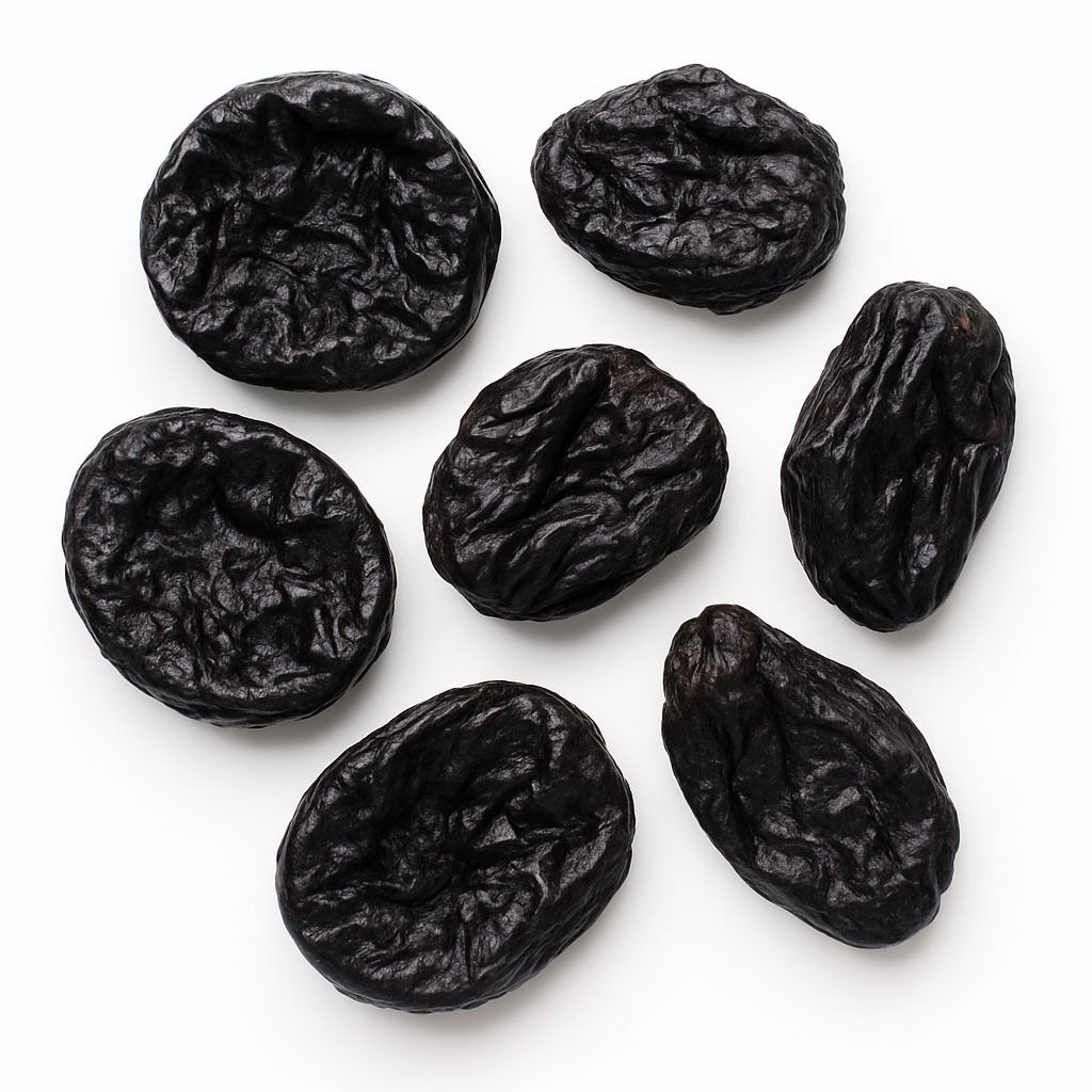 Seven whole dried prunes on white background