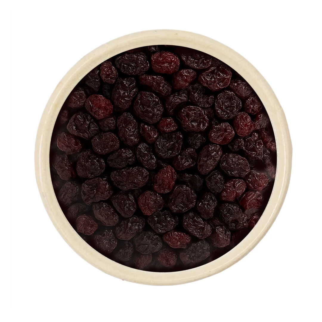 Top view of a bowl filled with dark dried raisins