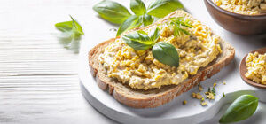 Egg salad sandwich with fresh basil on rustic bread